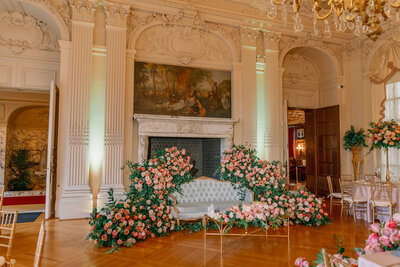 Sofa surrounded by pink roses at wedding reception, Unique Melody Events & Design helped with event