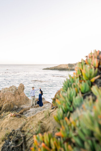 An adventurous couple poses along  the cliffs at their San Simeon engagement session