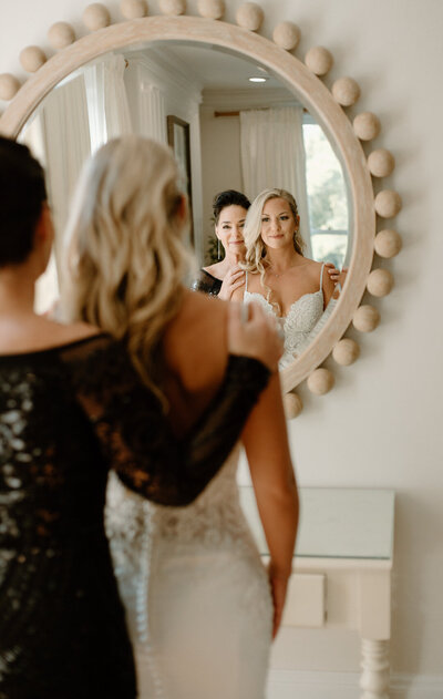 Bride getting ready for her wedding with her mother at Maple Grove Estate.