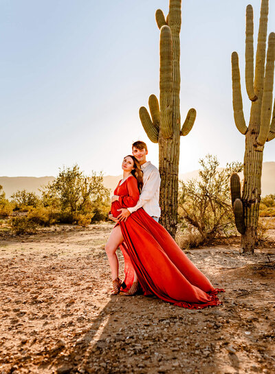 parents holding belly for Arizona maternity photographer