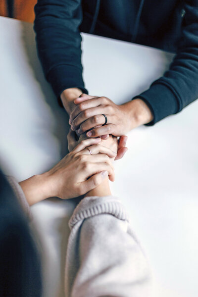 Couple holding hands during couples therapy