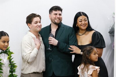 Wedding guests smiling and standing close together 