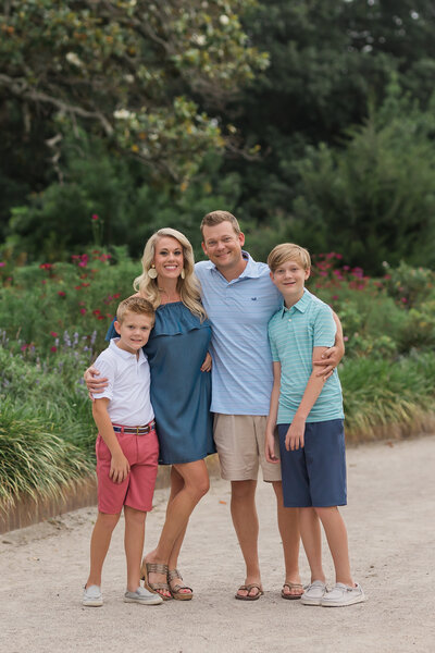 A family of four wearing casual clothing at a park in Summerville SC
