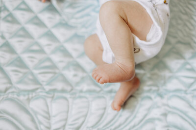 Couple holding their newborn baby in her nursery for an in-home lifestyle newborn photography session. 