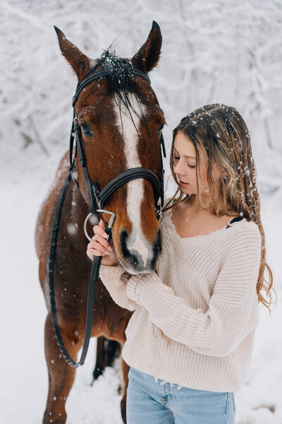 A girl in her horse getting photos done by Ashley Benedict Photography