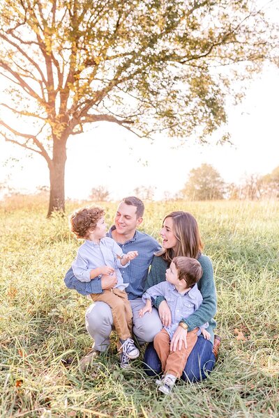 Family portraits in field at farm at sunset