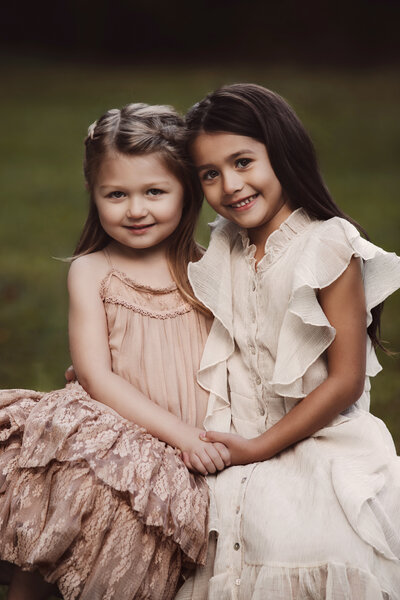 Family portrait of two sisters lovingly embracing each other