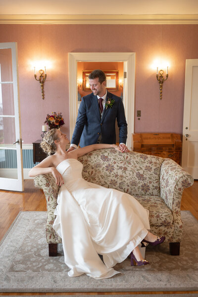 Groom kissing bride on the cheek after saying "I do" in Acadia National Park Maine 