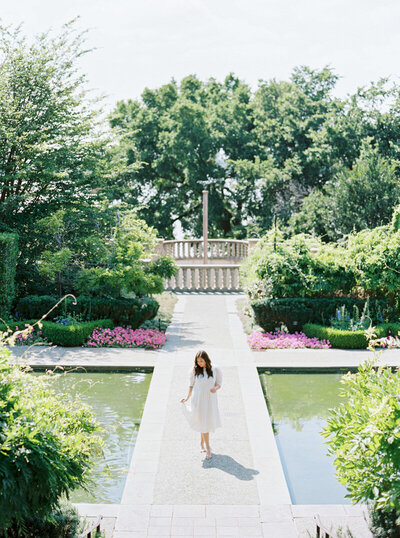 Dallas wedding photographer Alex walking in a garden