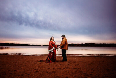 Couple holding pregnant belly