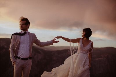 Couple reaches for each other at Taft Point