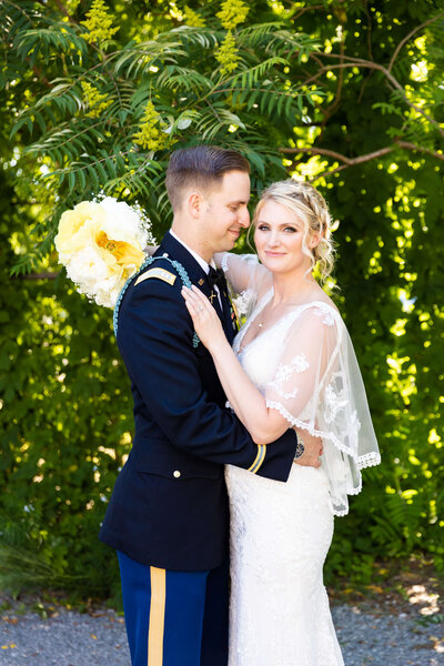 Bride and groom walking along a tree-lined path