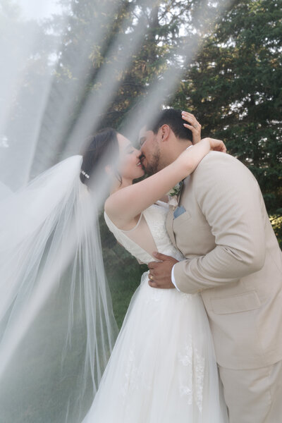 bride and groom kissing in portrait