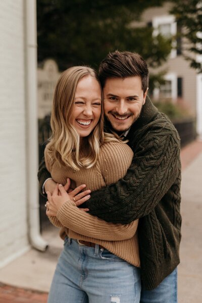 Emily and her husband smile and hug each other