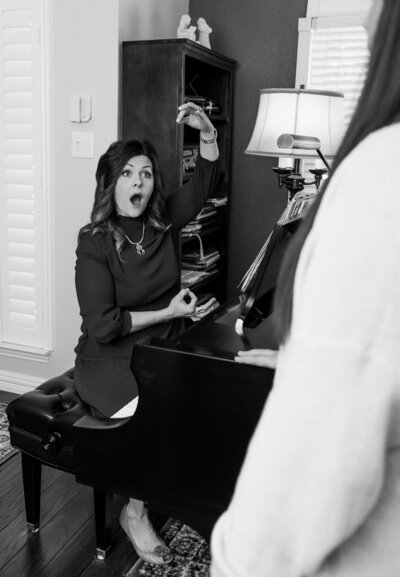 Amy Canchola teaches a vocal student singing lessons while seated at the piano