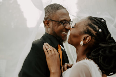 photo of bride and groom smiling at each other taken by Elopement photographers in Colorado