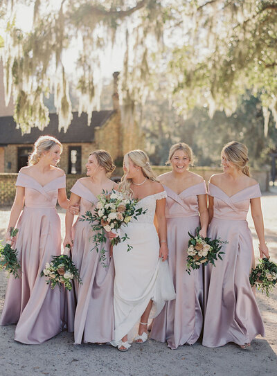 Off-the-shoulder wedding dress and mauve bridesmaid dresses for a Charleston destination wedding