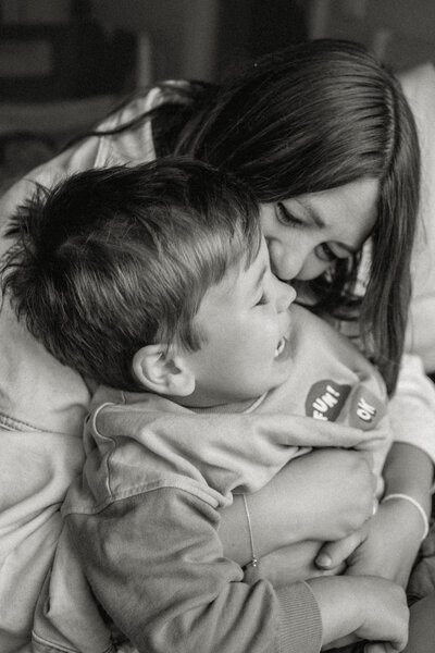 A joyful moment between mum and child, laughing together on the bed during a relaxed, at-home family photography session in Nottingham. Captured in natural light to reflect the warmth and connection of everyday life.