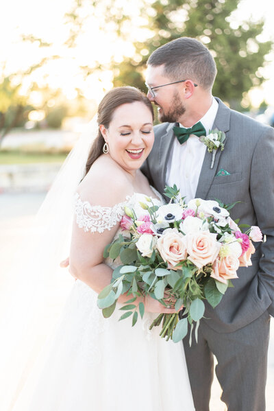 groom leaning in softly to bride's cheek