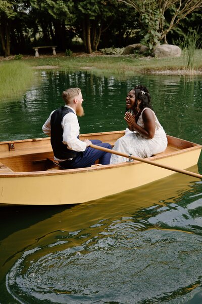 toledo wedding photographer takes a photo of a couple in a row boat