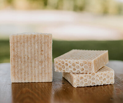 unscented oat and honey goat milk soap for eczema prone skin displayed on a table