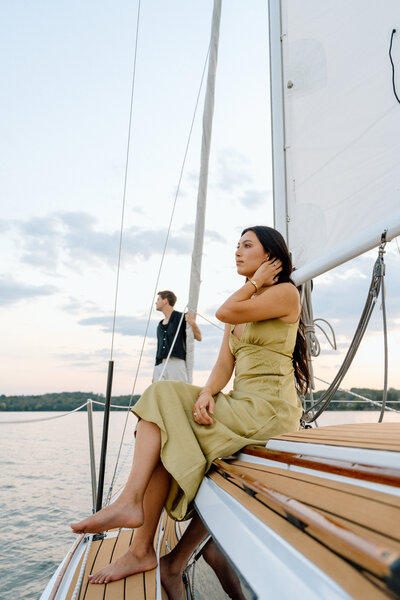 couple sitting on a sailboat on the lake