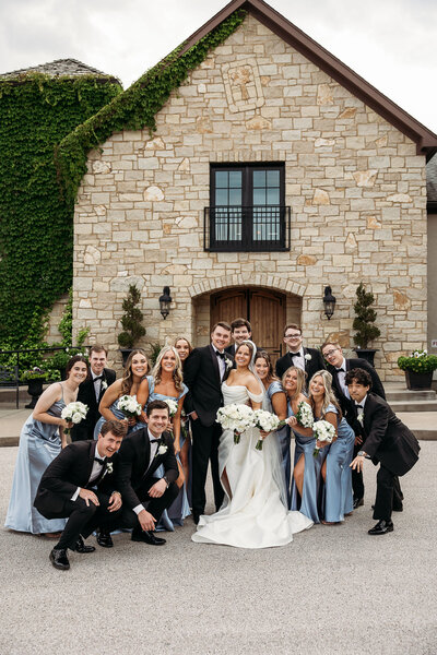 wedding party gathers with bride + groom outside of Silver Oaks
