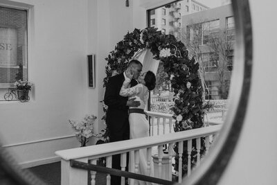 Bride and groom kissing in the mirror