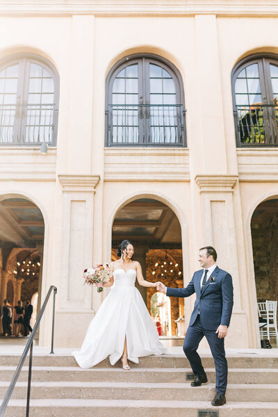 A wedding couple at Bella Collina in front of the bridge walking by Florida wedding photographer Angelika Krug Photo & Film