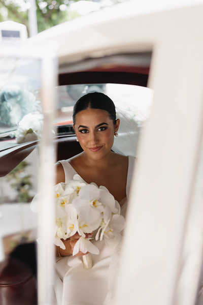 POC bride sitting in her wedding car on the way to get married | Sush Digital Media