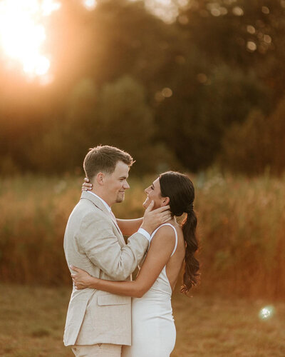 Bride and groom about to kiss in an outdoor scenery