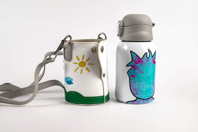 Product shot for a commercial client, Luua, of a water bottle and a matching case with strap, next to the bottle.