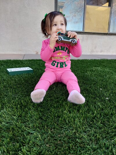 Young Girl Outside with Toys CPC Albuquerque Childcare