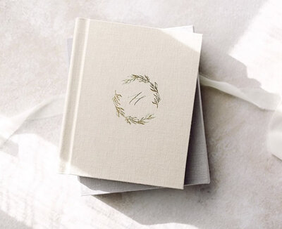 Elegant linen heirloom photo album with a custom botanical embossing, photographed in natural light as part of Little Palm's luxury printed photography experience in Northern California.