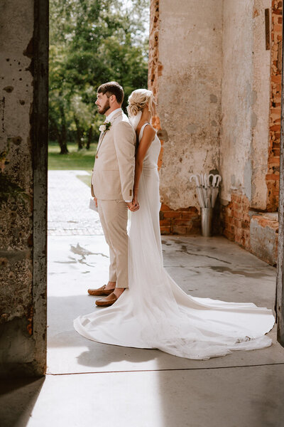 Bride and groom back to back