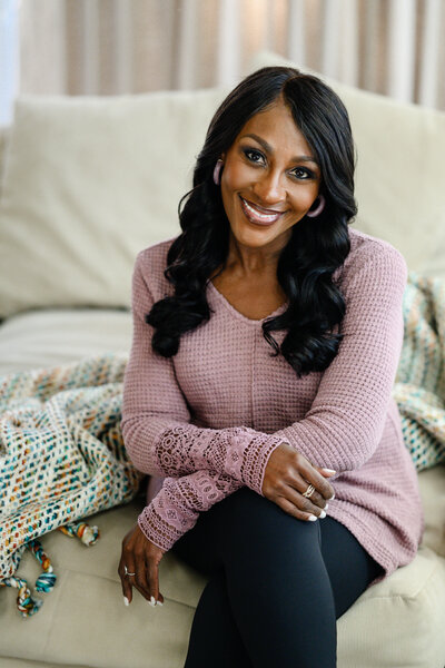 Portrait of Deme Riley, a transformational life coach helping women reclaim confidence and achieve personal breakthroughs.