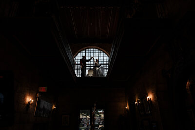 Artistic portrait of bride and groom at Treasury on the Plaza with soft light and subtle motion blur creating a romantic vibe.