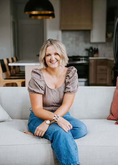 Maddie sitting on a coach at White Space Studio