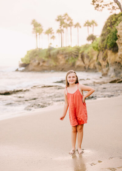 Little girl smiling on beach in Laguna Beach CA