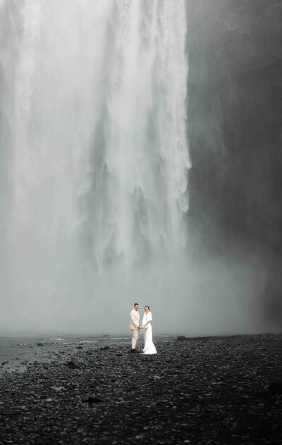 Destination elopement in Iceland in front of the Skógafoss waterfall