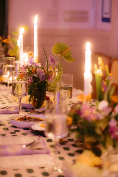 Candlelit wedding dinner at Saba with delicate florals and warm ambiance in New Orleans