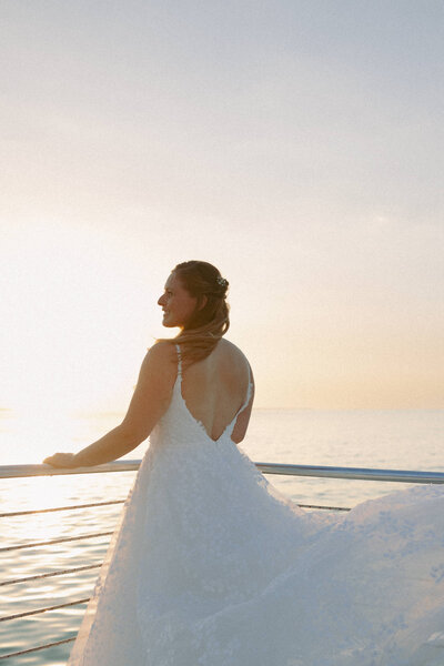 bride standing on the deck of a boat