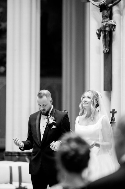 bride and groom feeling emotional during a Catholic Wedding Mass