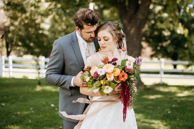 bride and groom sitting on loveseat