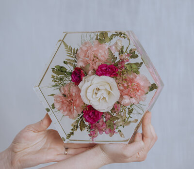 bouquet preserved in resin hexagon being held in hands