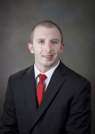 Man in a red tie and black suit