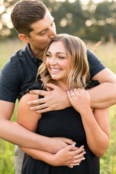 Couple embracing outside during engagement shoot