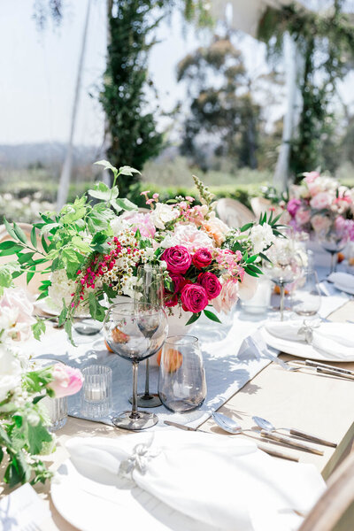 Table setting for Dinner reception in Montecito for birthday under clear-top tent