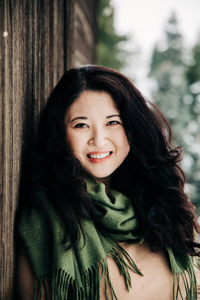 Female outdoor portraits next to the snowy winter barns in Washington