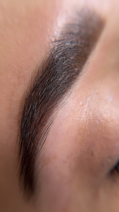 before and after brow transformation created by brow lamination, tint and wax
